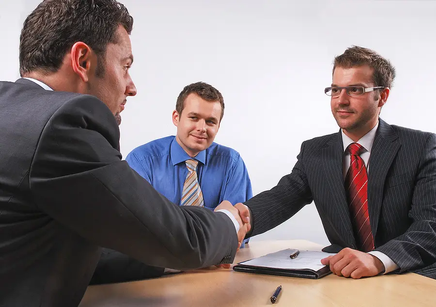 A salesman shaking hands with a customer