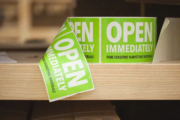 A roll of printed labels on a shelf